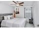 Stylish bedroom with guitar decorations, a surf board, and a neutral color scheme at 36312 Garden Wall Way, Zephyrhills, FL 33541