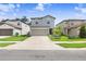 Exterior of a two-story home with well-maintained lawn, landscaping, and a two car garage at 36312 Garden Wall Way, Zephyrhills, FL 33541