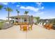 Outdoor community grilling area featuring stainless steel grills, seating, and scenic views at 36312 Garden Wall Way, Zephyrhills, FL 33541