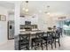 Modern kitchen with a large island, stainless steel appliances, and seamless flow to the dining area at 36312 Garden Wall Way, Zephyrhills, FL 33541