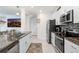 Modern kitchen with stainless steel appliances, granite counters, and white cabinetry at 36312 Garden Wall Way, Zephyrhills, FL 33541