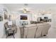 Spacious living room with modern decor, a large television, and seamless flow to the kitchen at 36312 Garden Wall Way, Zephyrhills, FL 33541