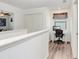 Bright loft area with desk, chair, and window, perfect for a home office at 36312 Garden Wall Way, Zephyrhills, FL 33541
