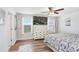 Light-filled main bedroom with wood floors and views of the neighborhood at 36312 Garden Wall Way, Zephyrhills, FL 33541