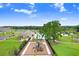 Modern community playground with colorful play structures and lush landscaping for Gathering enjoyment at 36312 Garden Wall Way, Zephyrhills, FL 33541