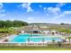 Resort-style community pool with ample lounge seating and lush landscaping in a vibrant neighborhood at 36312 Garden Wall Way, Zephyrhills, FL 33541