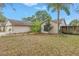 Well-maintained front yard featuring lush greenery and mature trees enhancing the home's curb appeal at 4806 Country Hills Dr, Tampa, FL 33624