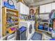 A very organized laundry room with front-load washer and dryer and lots of storage space at 4806 Country Hills Dr, Tampa, FL 33624