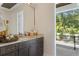 Bathroom boasts granite countertops, dark wood cabinets, and access to a private balcony at 4807 W Longfellow Ave, Tampa, FL 33629