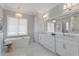 Luxurious bathroom with a freestanding tub, double vanity, and elegant lighting at 4807 W Longfellow Ave, Tampa, FL 33629