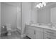 Bright bathroom with white cabinets, marble countertop, and subway tile shower and gray tiled flooring at 4807 W Longfellow Ave, Tampa, FL 33629