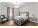 Elegant bedroom with decorative lighting, a mirrored side table, and hardwood flooring at 4807 W Longfellow Ave, Tampa, FL 33629