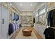 Expansive walk-in closet with custom shelving, drawers, rods, recessed lighting and a central island for organized storage at 4807 W Longfellow Ave, Tampa, FL 33629