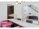 Dining room with a view of the foyer, white table, and pink velvet chairs at 4807 W Longfellow Ave, Tampa, FL 33629