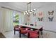 Sophisticated dining area showcasing a statement light fixture, butterfly wall art, and stylish velvet seating at 4807 W Longfellow Ave, Tampa, FL 33629