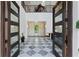 Elegant foyer with soaring ceilings, checkered marble floors, and grand entry doors at 4807 W Longfellow Ave, Tampa, FL 33629