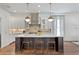 Modern kitchen with stainless steel appliances, a large island, and pendant lighting at 4807 W Longfellow Ave, Tampa, FL 33629