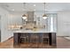 Modern kitchen with a large center island, pendant lighting, and stainless steel appliances at 4807 W Longfellow Ave, Tampa, FL 33629