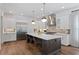 Spacious kitchen with white cabinets, stainless steel appliances, and a large center island with seating at 4807 W Longfellow Ave, Tampa, FL 33629