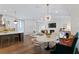Open-concept living area featuring a kitchen, dining space, living room, and modern decor at 4807 W Longfellow Ave, Tampa, FL 33629
