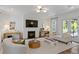 Cozy living room with a white brick fireplace, plush seating, and wood floors at 4807 W Longfellow Ave, Tampa, FL 33629