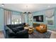 Comfortable living room features a large sectional sofa, modern lighting, and stylish decor at 4807 W Longfellow Ave, Tampa, FL 33629