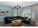 Serene living room featuring an oversized sectional sofa, ambient light, and custom window treatments at 4807 W Longfellow Ave, Tampa, FL 33629