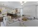 Open-concept living space featuring hardwood floors, white walls, and modern furnishings at 4807 W Longfellow Ave, Tampa, FL 33629