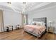 Spacious main bedroom featuring elegant chandelier lighting and hardwood floors at 4807 W Longfellow Ave, Tampa, FL 33629