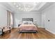 Spacious main bedroom features elegant chandelier lighting and hardwood floors at 4807 W Longfellow Ave, Tampa, FL 33629