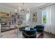 Well-lit home office with large windows, modern decor, a unique light fixture, and hardwood floors at 4807 W Longfellow Ave, Tampa, FL 33629