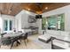Outdoor kitchen and dining area featuring stainless steel appliances and comfortable seating at 4807 W Longfellow Ave, Tampa, FL 33629