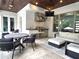 Outdoor kitchen with a stainless steel grill, sink, and built-in cabinets plus outdoor dining area at 4807 W Longfellow Ave, Tampa, FL 33629