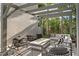 Stylish outdoor patio with comfortable seating around a modern fire pit, shaded by a wooden pergola and lush landscaping at 4807 W Longfellow Ave, Tampa, FL 33629