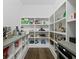 Walk-in pantry with custom shelving, stainless steel appliances, and hardwood floors at 4807 W Longfellow Ave, Tampa, FL 33629