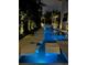 Stunning pool with lighted chaise lounges, flowing water feature, and lush tropical landscaping at night at 4807 W Longfellow Ave, Tampa, FL 33629