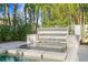 Modern pool featuring a decorative water feature and lush tropical landscaping at 4807 W Longfellow Ave, Tampa, FL 33629