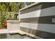 Elegant pool with waterfall feature and black and white striped tiling creates a sophisticated outdoor ambiance at 4807 W Longfellow Ave, Tampa, FL 33629
