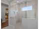 Sleek shower featuring glass enclosure, stylish tile accents and dual shower heads at 4807 W Longfellow Ave, Tampa, FL 33629