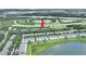 A beautiful aerial view of a residential community with lush green landscaping, a lake, and nearby highway access at 4910 Chatham Gate Dr, Riverview, FL 33578