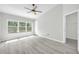 Bright bedroom with neutral walls, stylish ceiling fan, and sunlit windows showcasing the outdoor scenery at 4910 Chatham Gate Dr # Dr, Riverview, FL 33578