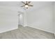 Cozy bedroom featuring wood-look flooring, a ceiling fan, and a closet with sliding doors at 4910 Chatham Gate Dr, Riverview, FL 33578