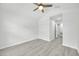 Clean bedroom featuring wood-look flooring, ceiling fan, and a doorway leading to other rooms at 4910 Chatham Gate Dr, Riverview, FL 33578