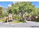 Inviting entrance to a gated community with lush greenery, brick pillars and mature trees at 4910 Chatham Gate Dr, Riverview, FL 33578