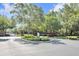Welcoming entrance to a gated community, framed by mature trees, manicured landscaping and brick pillars at 4910 Chatham Gate Dr, Riverview, FL 33578