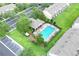 Aerial view of a luxurious community pool with lounge chairs, a clubhouse, and parking spaces at 4910 Chatham Gate Dr, Riverview, FL 33578