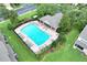 Overhead view of a community pool surrounded by lush landscaping, lounge seating and a shaded pavilion at 4910 Chatham Gate Dr, Riverview, FL 33578
