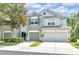 Inviting two-story townhome with a two-car garage and lush green landscaping at 4910 Chatham Gate Dr, Riverview, FL 33578