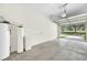 Spacious garage featuring concrete flooring, water filtration system, and access to the outdoors at 4910 Chatham Gate Dr, Riverview, FL 33578