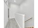Bright hallway features modern gray flooring, fresh white walls, and a staircase at 4910 Chatham Gate Dr, Riverview, FL 33578